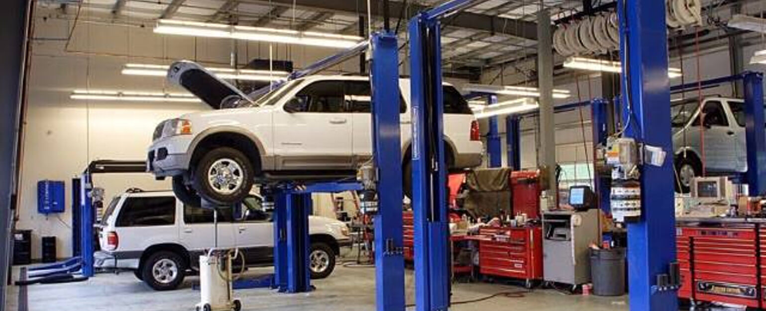 Vehicle lift, lifting up an SUV. Installed by Southeeastern Shop Services Corp.